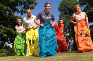 Adults having fun in a potato sack race