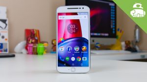 Moto G4 plus cell phone standing upright